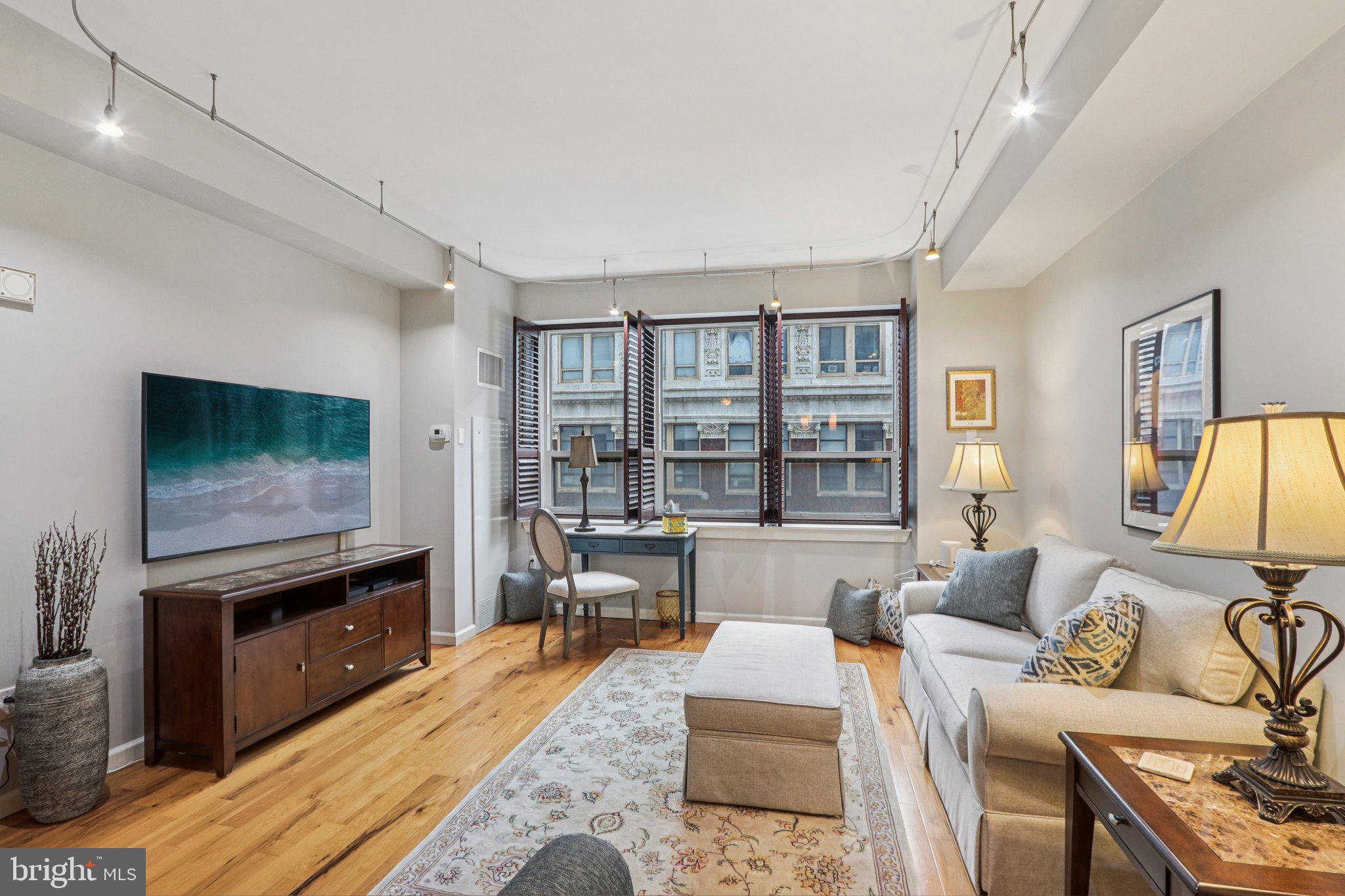 1425 Locust Street, Unit 7D Philadelphia, PA 19102 - Photo 14 of 39 a living room with furniture and a flat screen tv