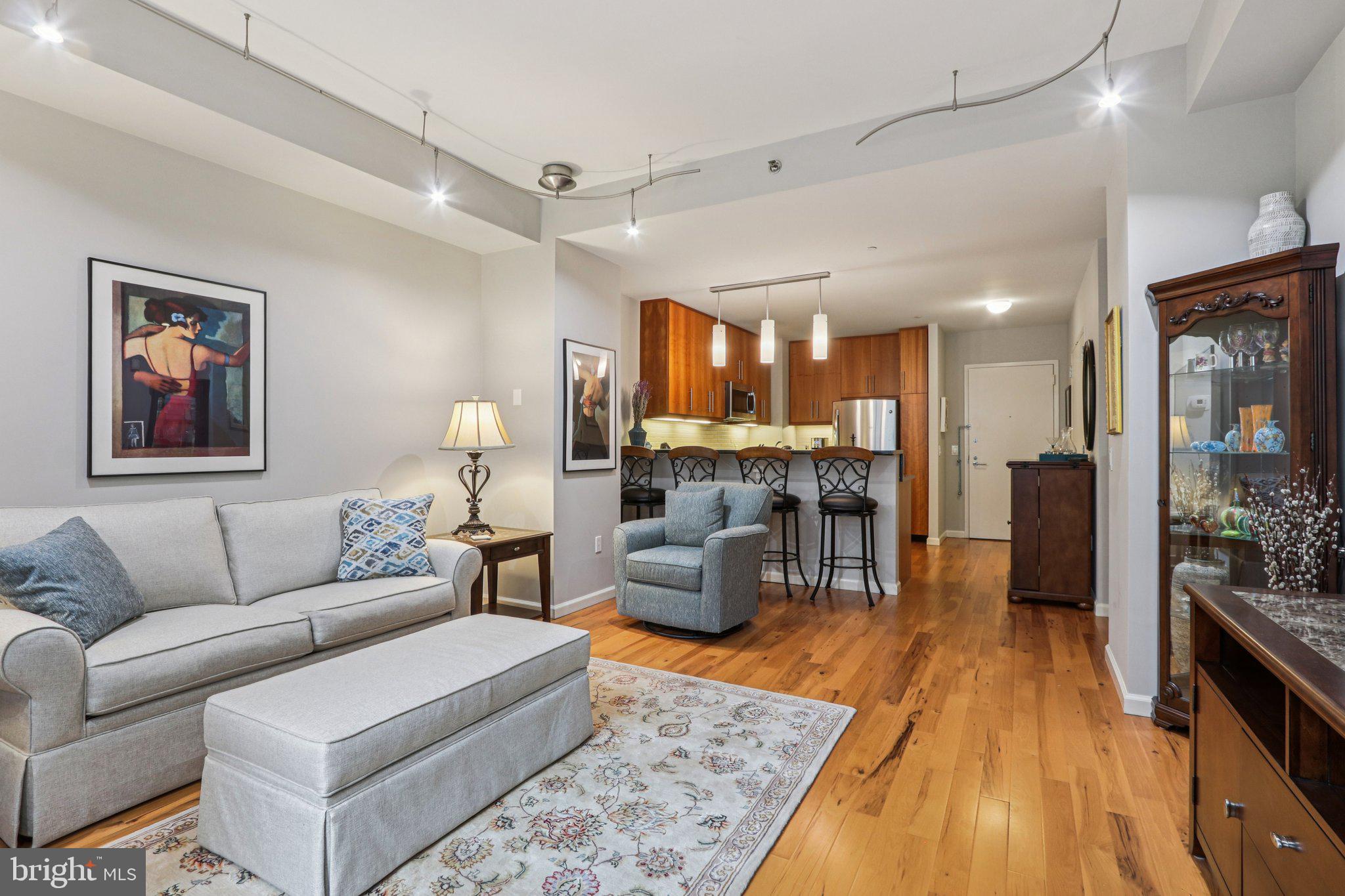 1425 Locust Street, Unit 7D Philadelphia, PA 19102 - Photo 15 of 39 a living room with furniture and a wooden floor