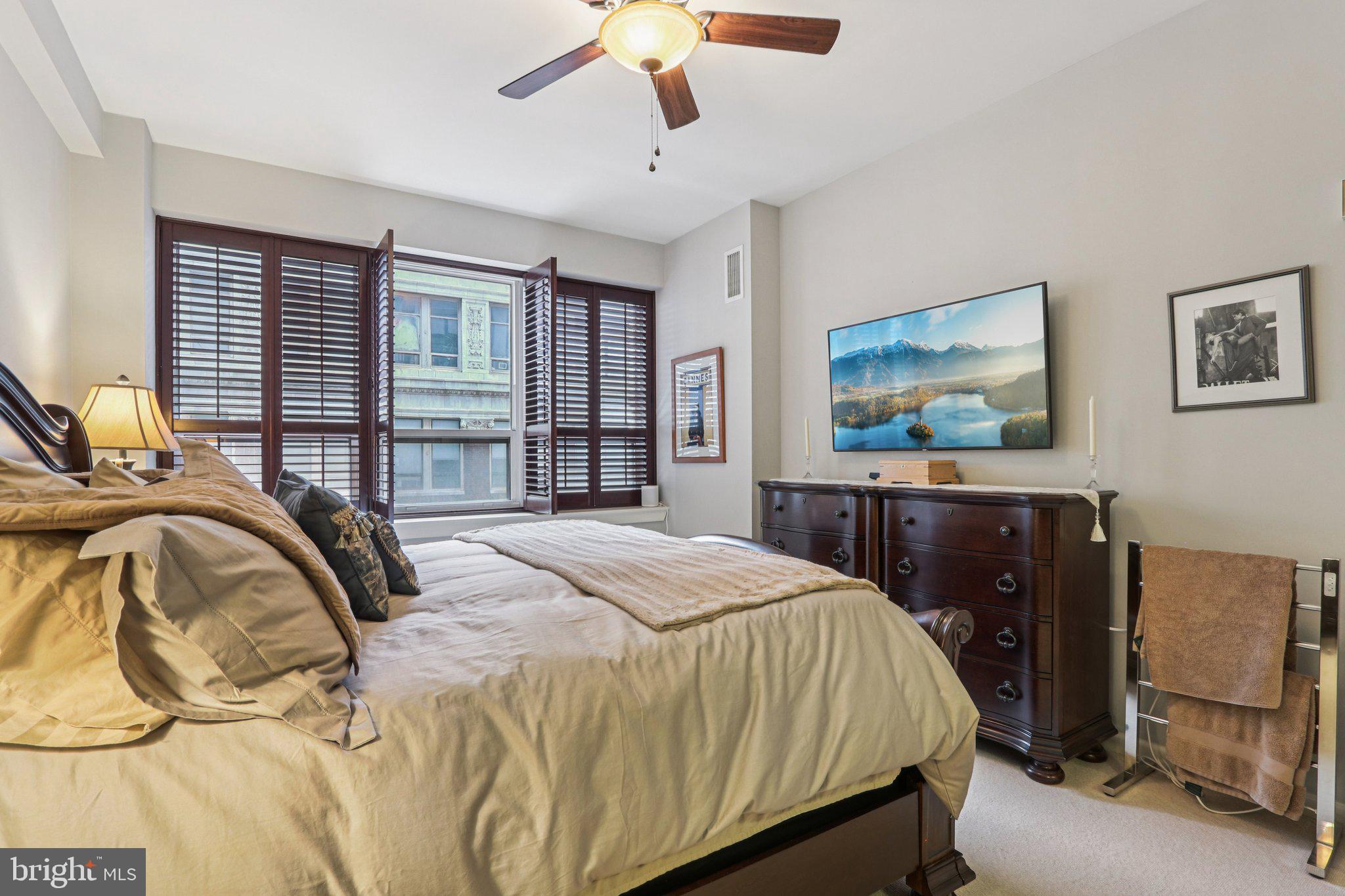 1425 Locust Street, Unit 7D Philadelphia, PA 19102 - Photo 21 of 39 a bedroom with a bed and wooden floor