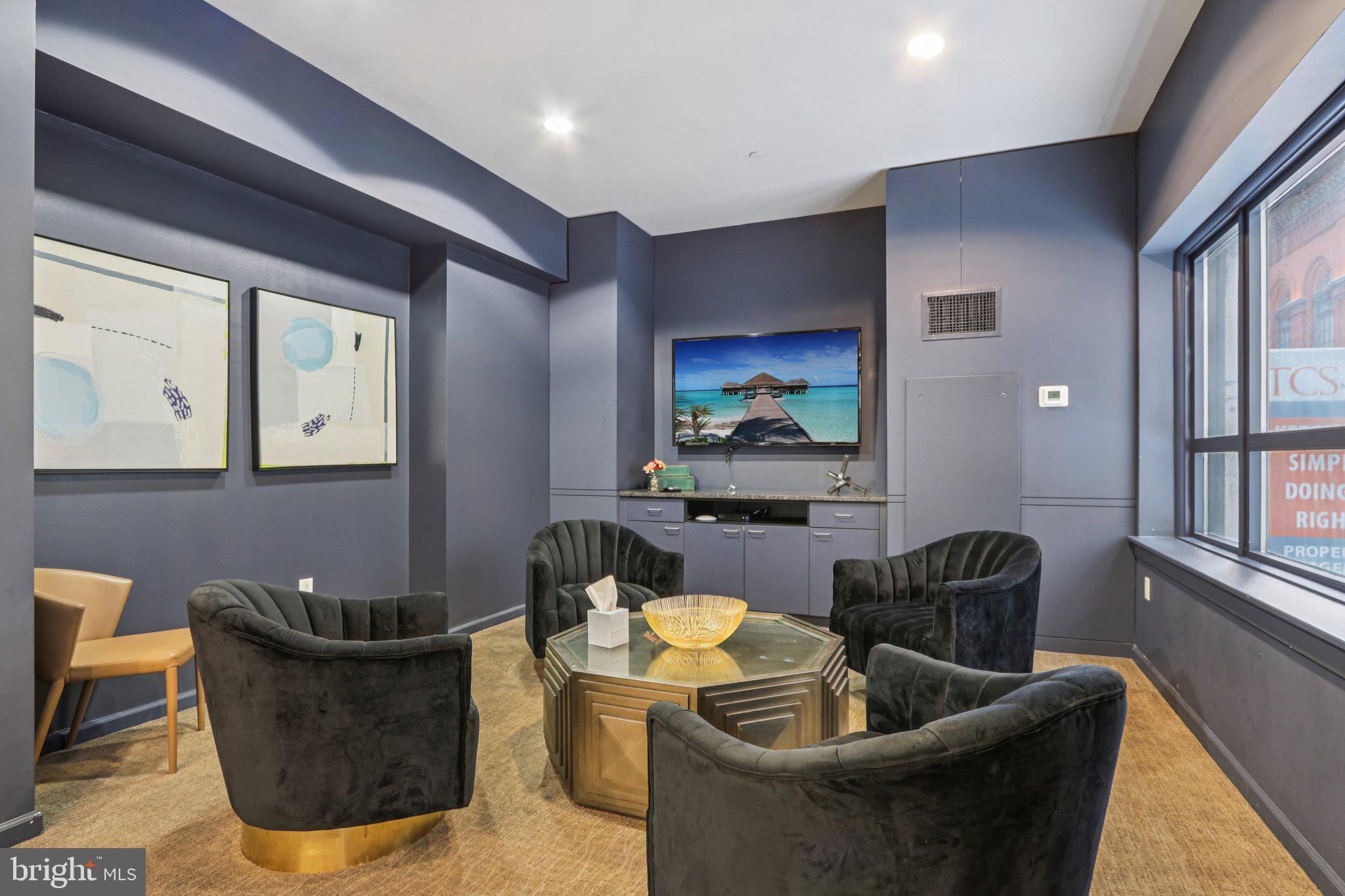 1425 Locust Street, Unit 7D Philadelphia, PA 19102 - Photo 24 of 39 a living room with furniture and a potted plant
