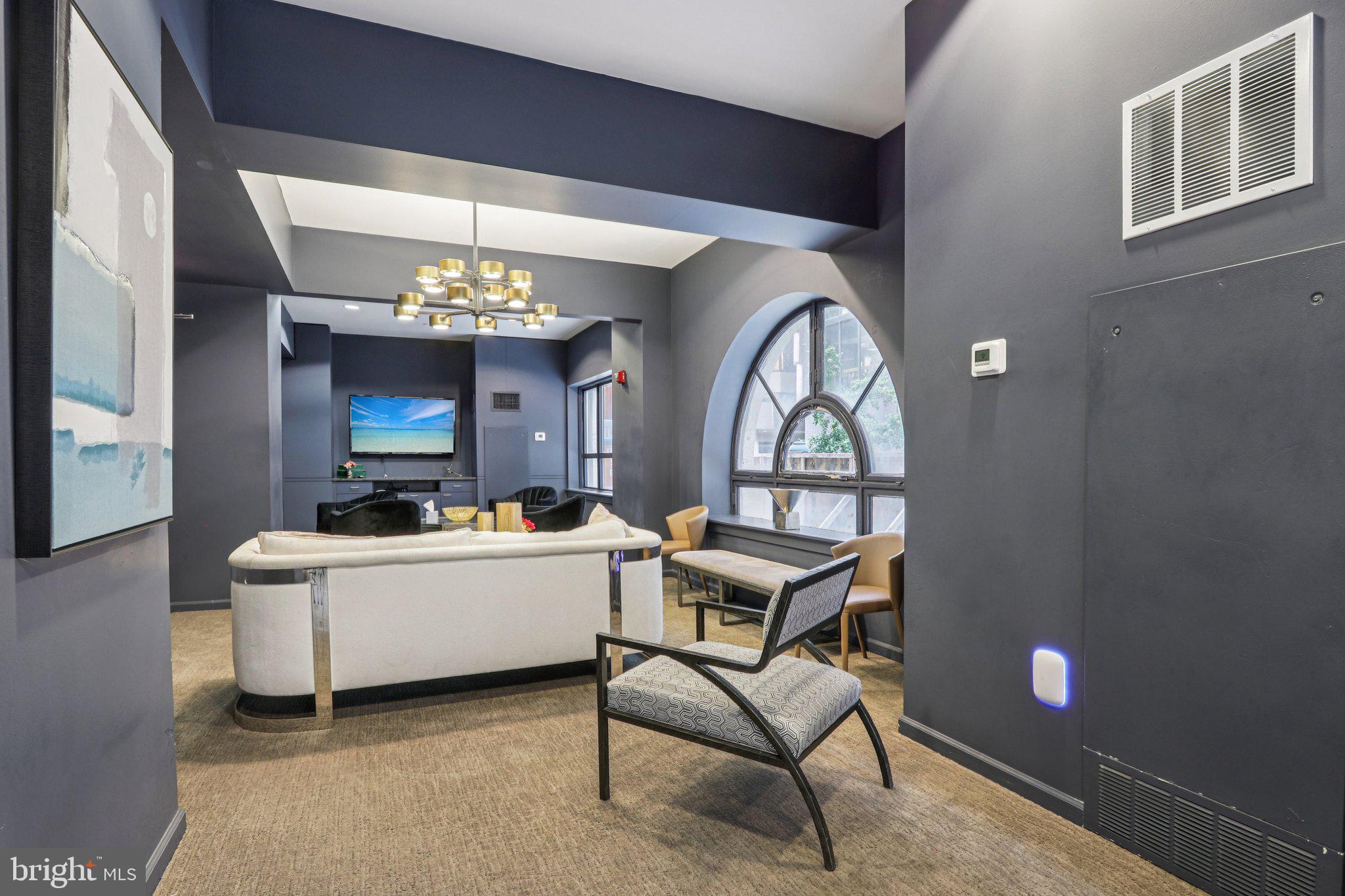 1425 Locust Street, Unit 7D Philadelphia, PA 19102 - Photo 26 of 39 a living room with furniture and a chandelier