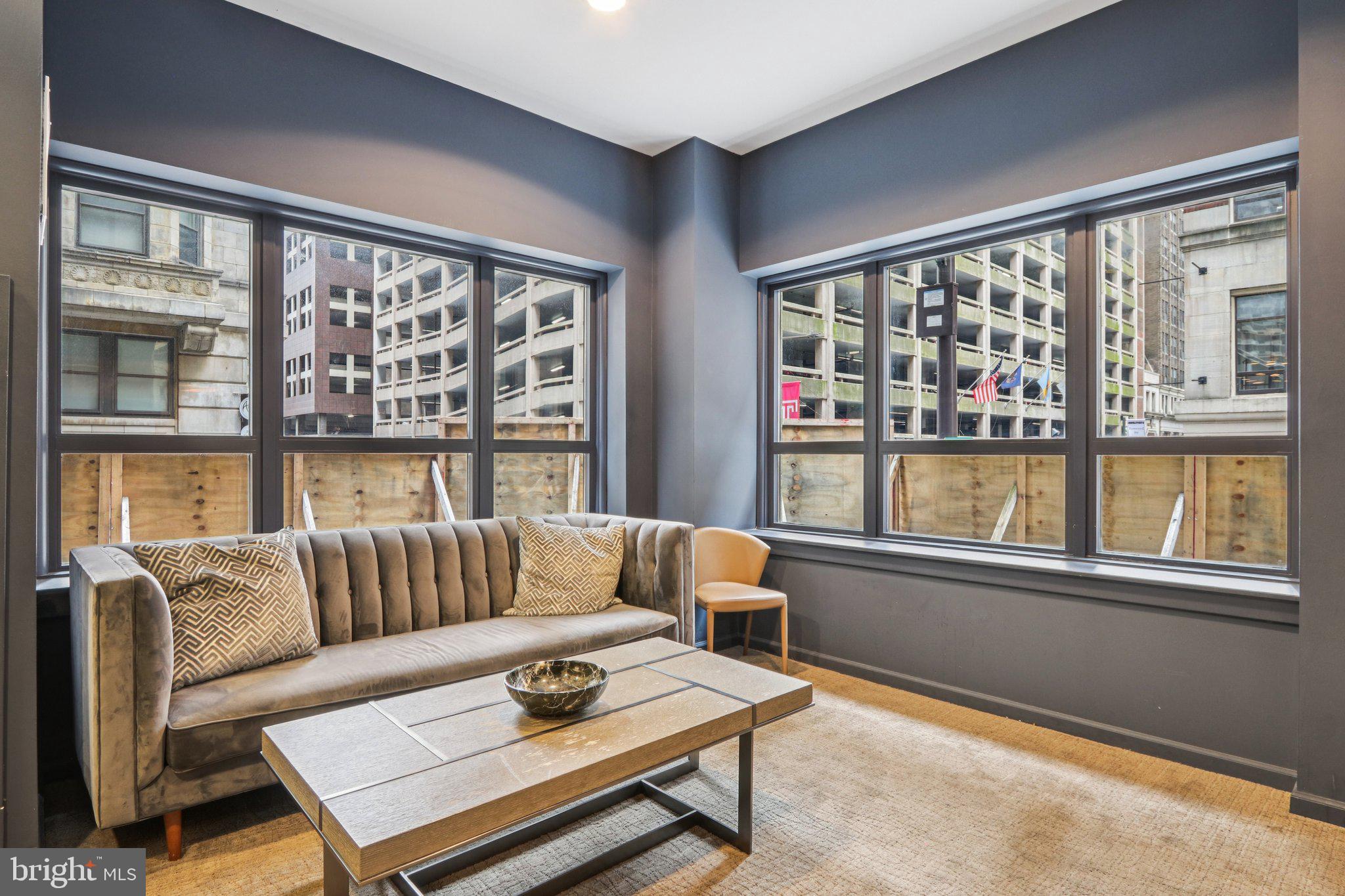 1425 Locust Street, Unit 7D Philadelphia, PA 19102 - Photo 27 of 39 a living room with furniture and a window