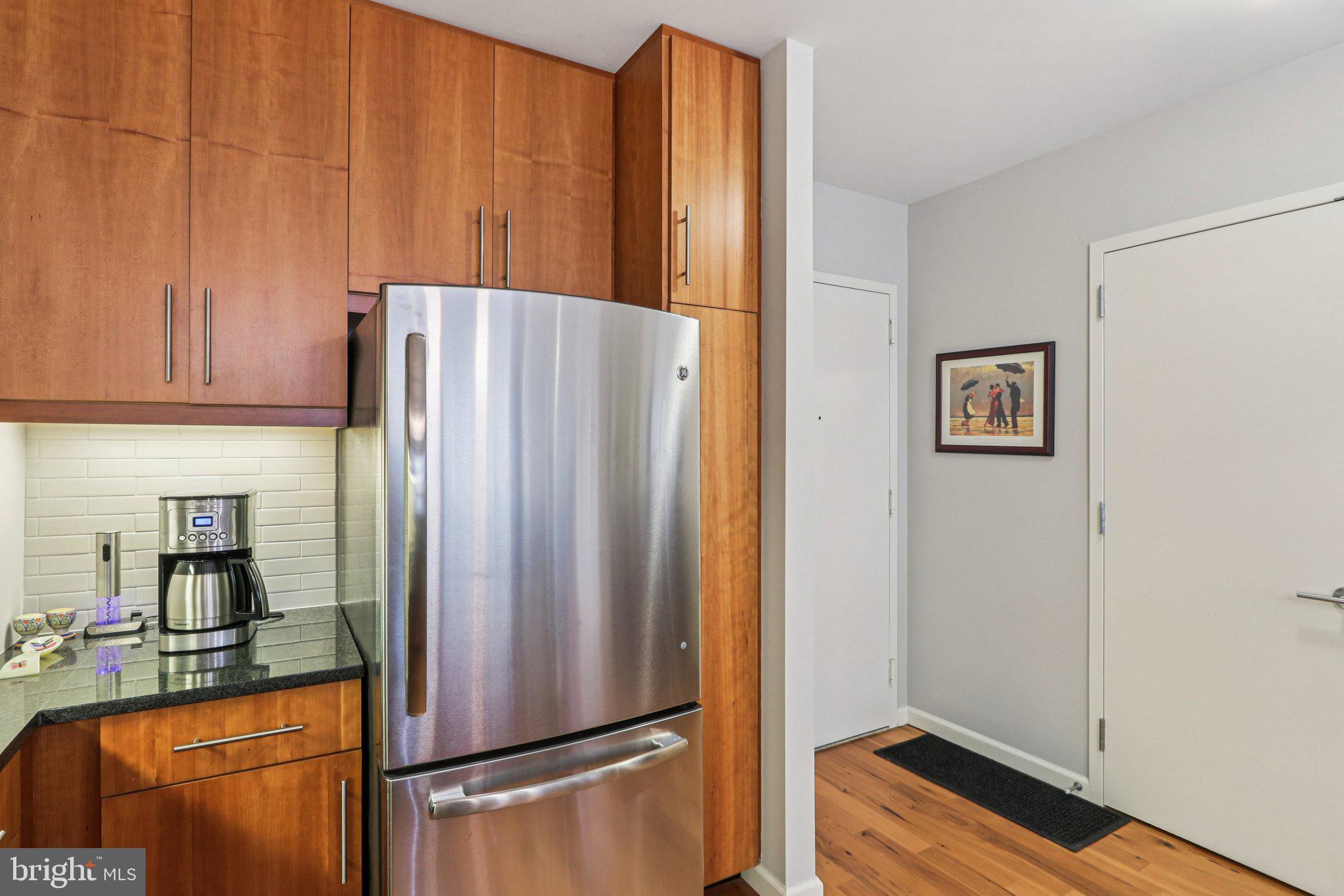 1425 Locust Street, Unit 7D Philadelphia, PA 19102 - Photo 5 of 39 a white refrigerator freezer sitting in a kitchen