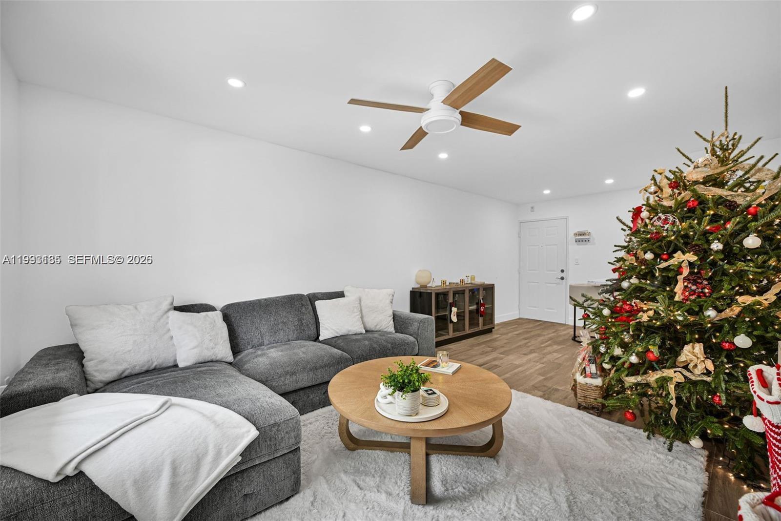 8609 Southwest 68th Court, Unit 24 Pinecrest, FL 33156 - Photo 2 of 39 a living room with furniture and a potted plant
