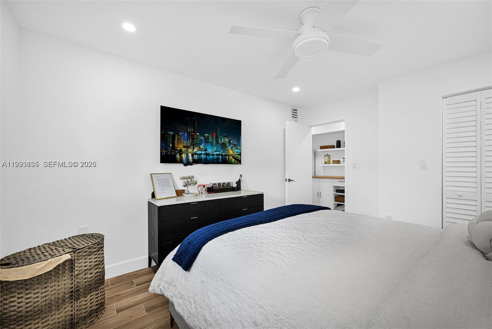 8609 Southwest 68th Court, Unit 24 Pinecrest, FL 33156 - Photo 22 of 39 a bedroom with a bed and a flat screen tv