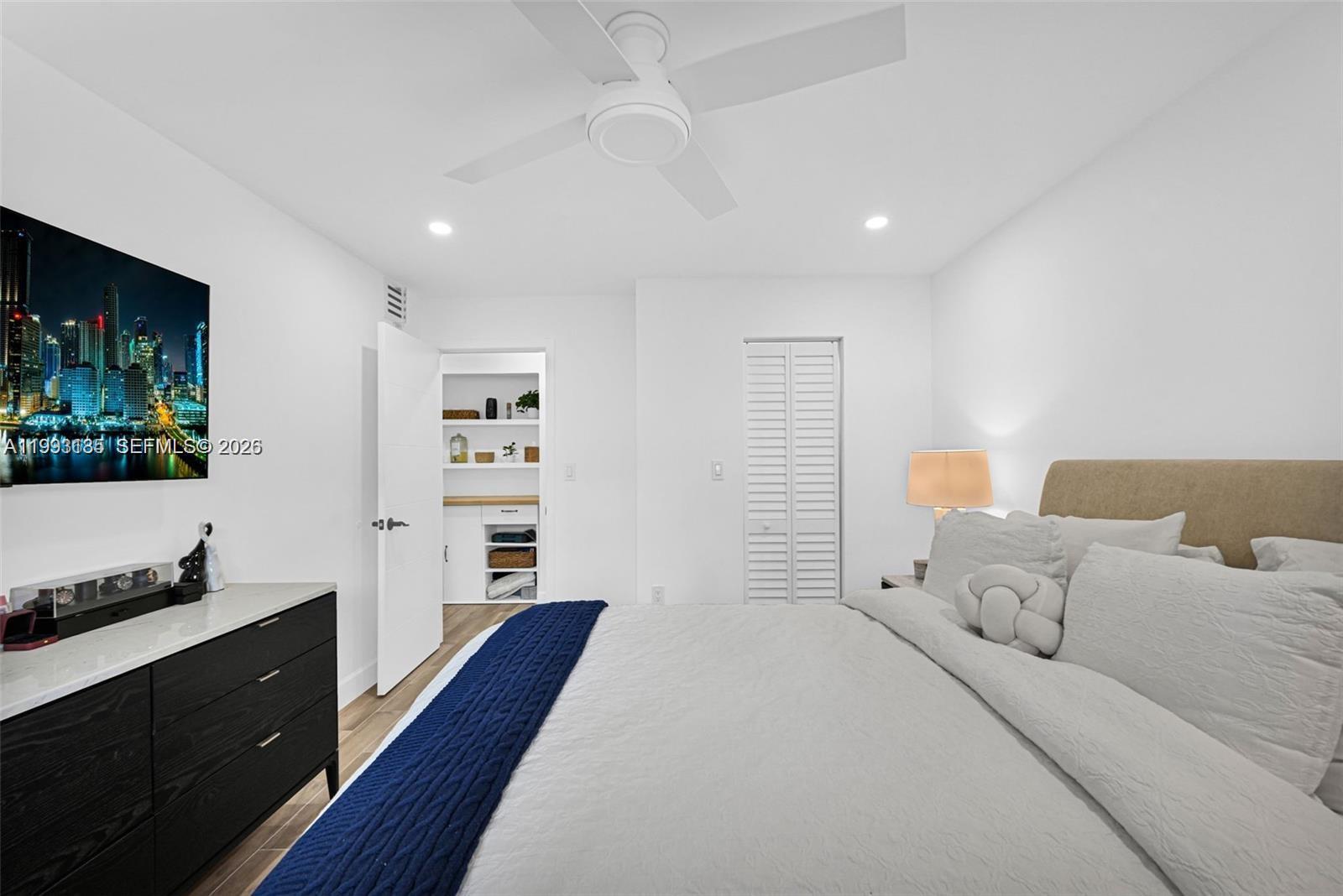 8609 Southwest 68th Court, Unit 24 Pinecrest, FL 33156 - Photo 23 of 39 a bedroom with a bed and a dresser in it