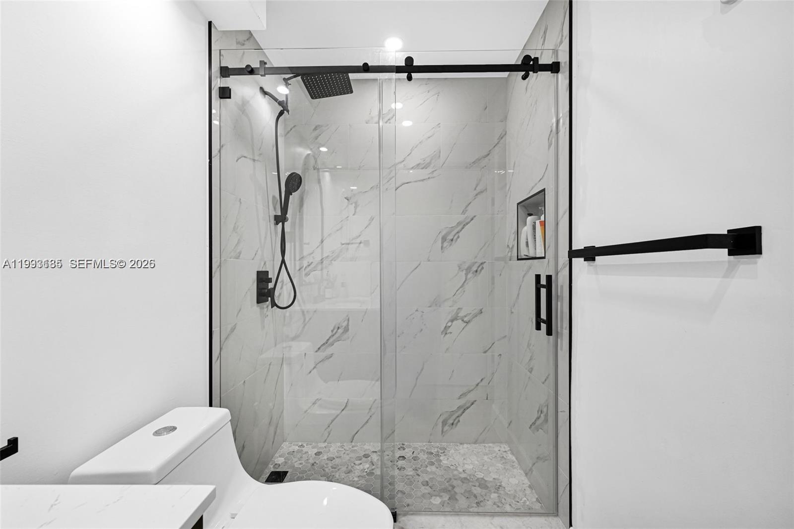 8609 Southwest 68th Court, Unit 24 Pinecrest, FL 33156 - Photo 28 of 39 a bathroom with a shower and toilet