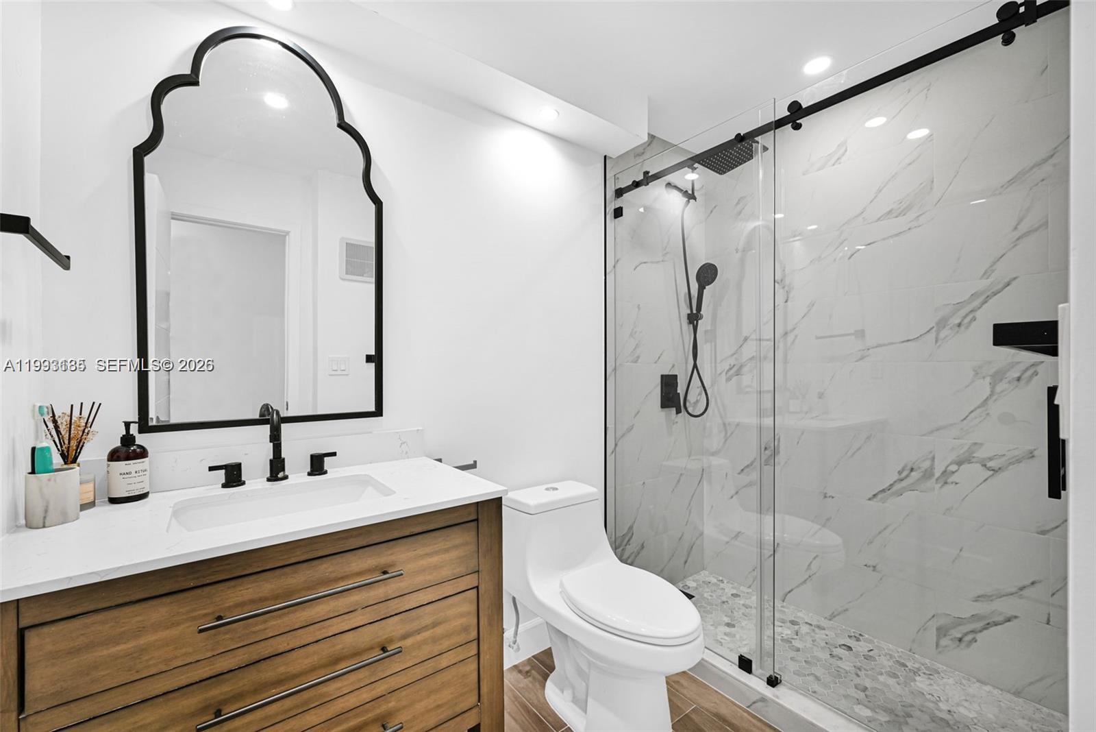 8609 Southwest 68th Court, Unit 24 Pinecrest, FL 33156 - Photo 29 of 39 a bathroom with a sink toilet and shower
