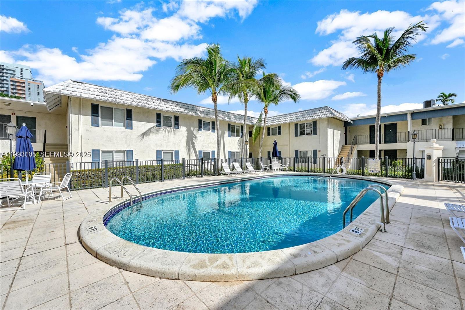 8609 Southwest 68th Court, Unit 24 Pinecrest, FL 33156 - Photo 35 of 39 a view of a swimming pool with a patio