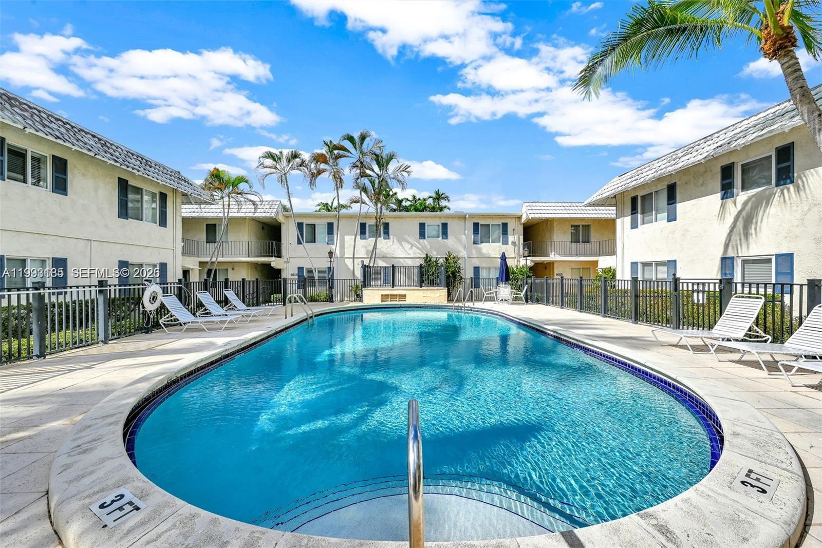 8609 Southwest 68th Court, Unit 24 Pinecrest, FL 33156 - Photo 36 of 39 a view of a swimming pool with outdoor seating