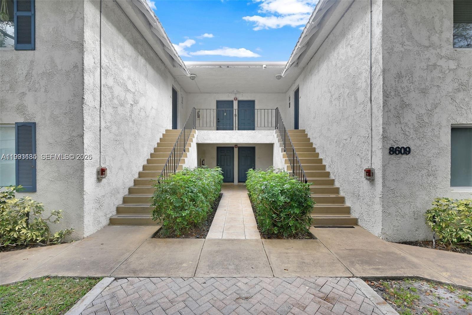 8609 Southwest 68th Court, Unit 24 Pinecrest, FL 33156 - Photo 5 of 39 a view of house with potted plants