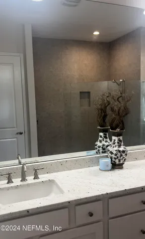 a bathroom with a sink a vanity and a mirror