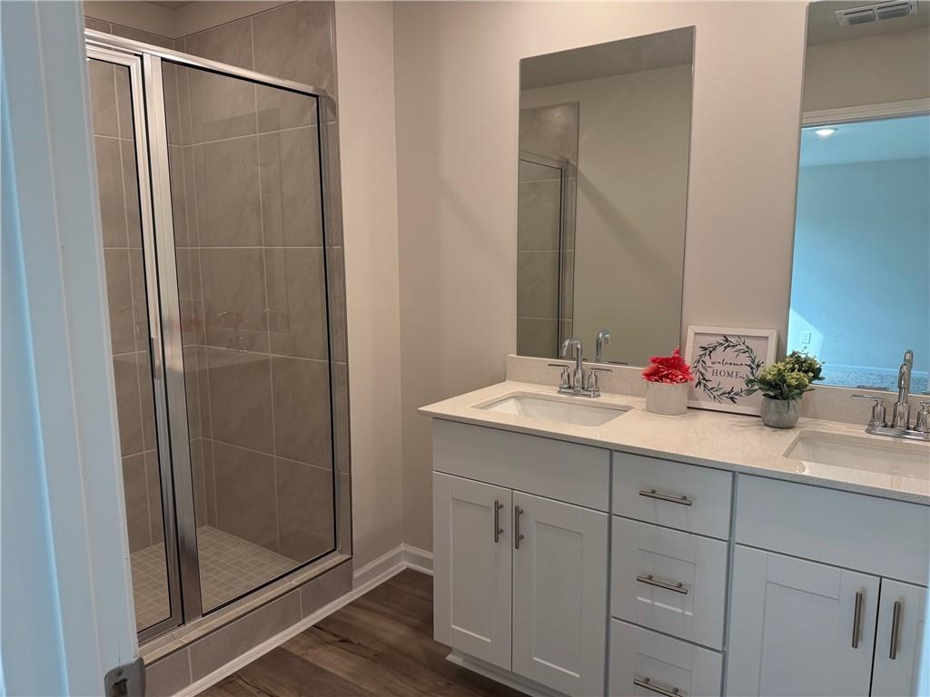 2496 Rocky City Lane Snellville, GA 30078 - Photo 6 of 15 a bathroom with a shower sink and mirror