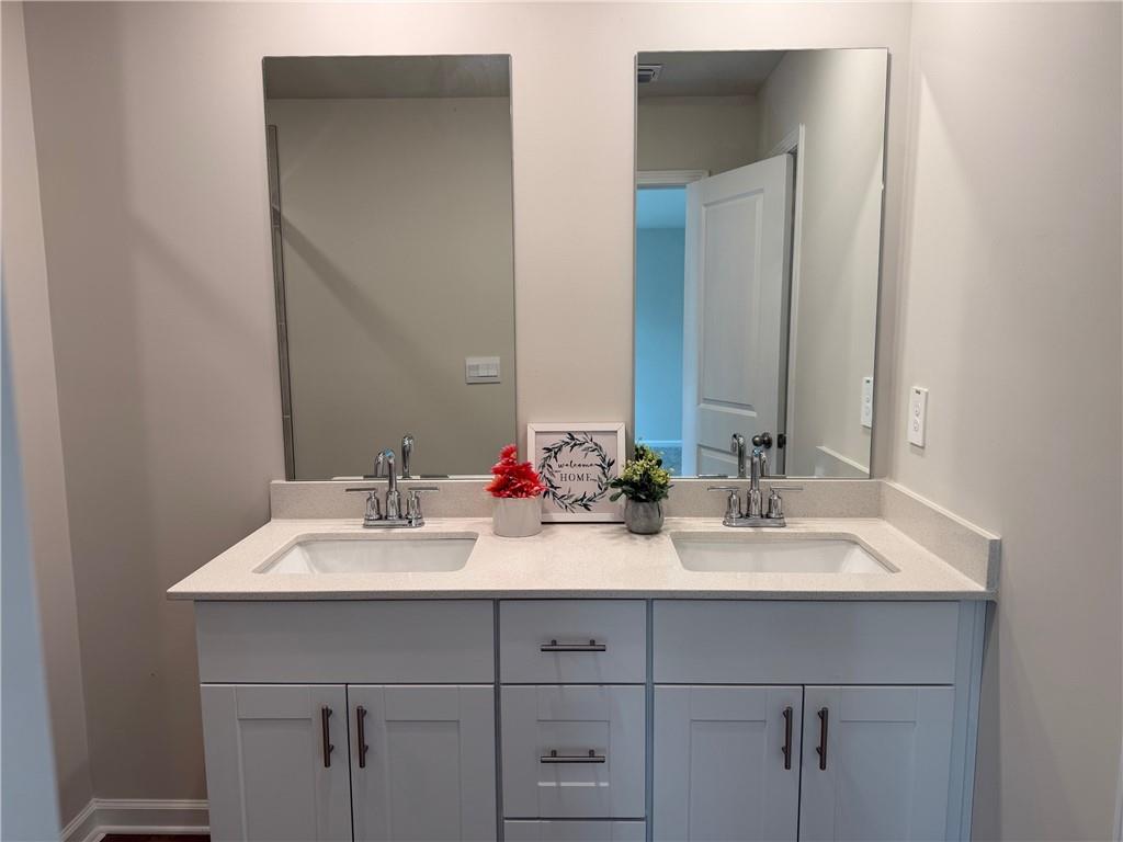 2496 Rocky City Lane Snellville, GA 30078 - Photo 7 of 15 a bathroom with double sink and a mirror