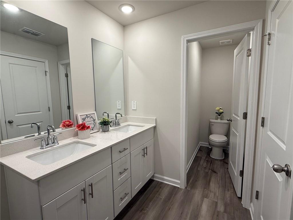 2496 Rocky City Lane Snellville, GA 30078 - Photo 9 of 15 a bathroom with a sink vanity toilet and shower
