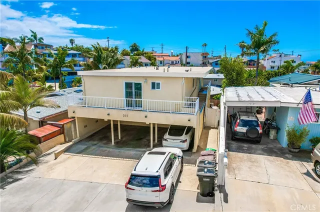 a view of a patio with table and chairs potted plants and a large tree