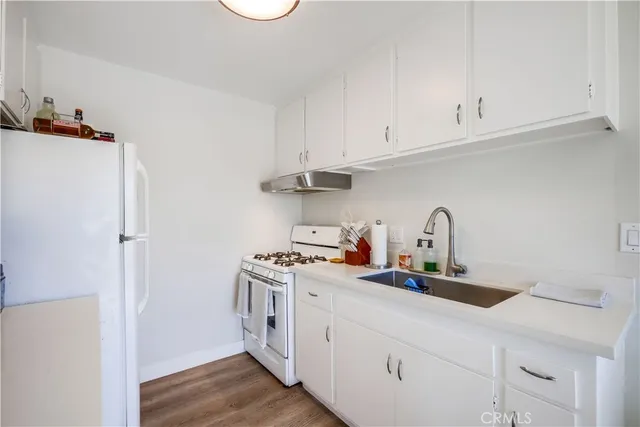 a kitchen with stainless steel appliances a sink stove and cabinets