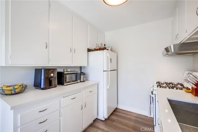 a kitchen with refrigerator and cabinets