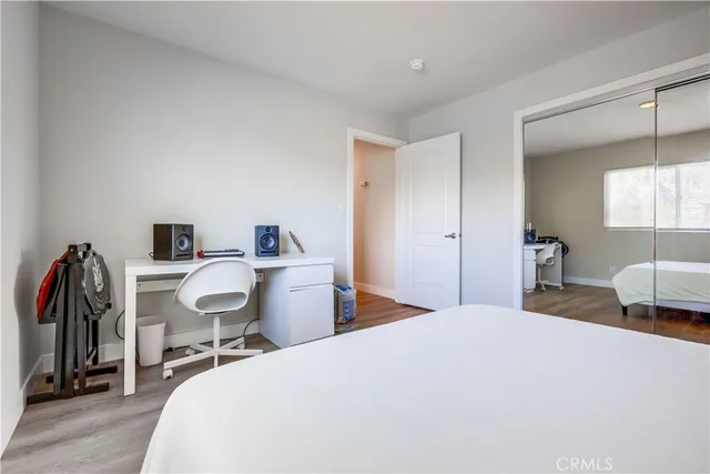 a bedroom with a bed and a chair