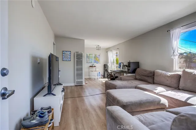 a living room with furniture window and a flat screen tv