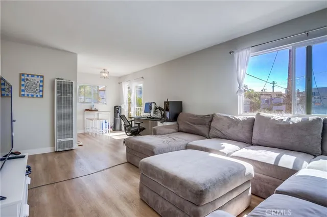 a living room with furniture and large windows