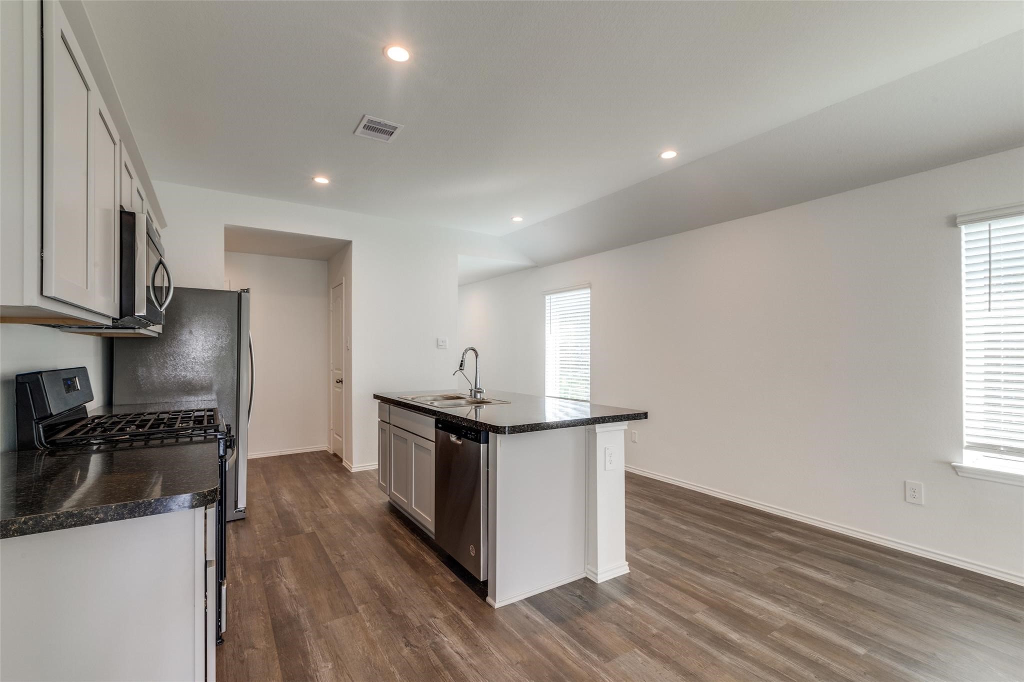 24323 Cayman Heights Lane Spring, TX 77373 - Photo 9 of 12 a kitchen with stainless steel appliances granite countertop a stove and a refrigerator