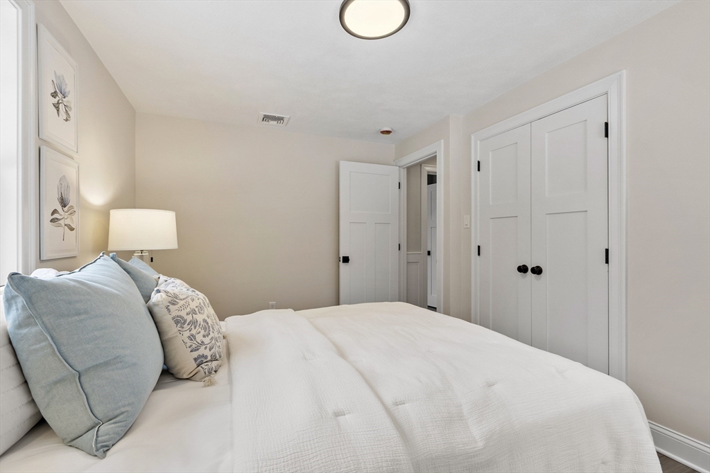 4 Richard Road Hudson, MA 01749 - Photo 18 of 40 a bedroom with a bed and a lamp