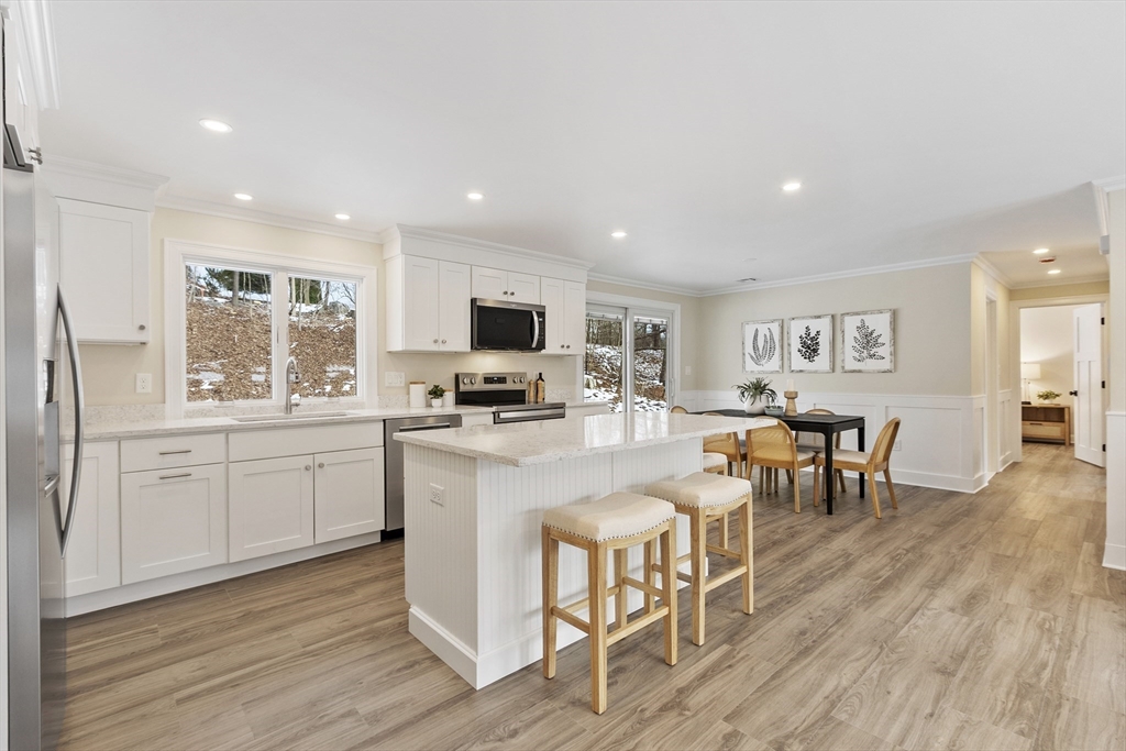4 Richard Road Hudson, MA 01749 - Photo 3 of 40 a kitchen with white cabinets and chairs