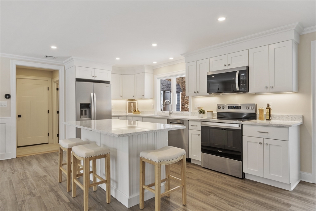 4 Richard Road Hudson, MA 01749 - Photo 4 of 40 a kitchen with kitchen island granite countertop a sink and stainless steel appliances