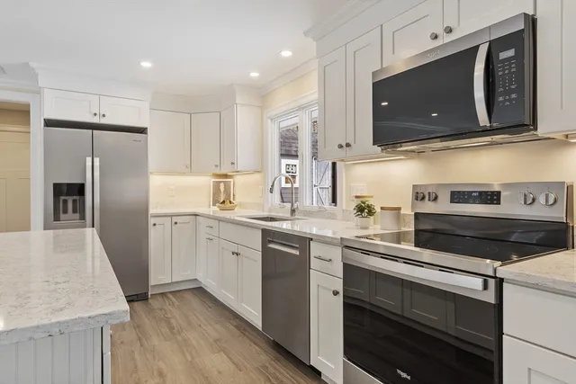 a kitchen with a sink stove and refrigerator
