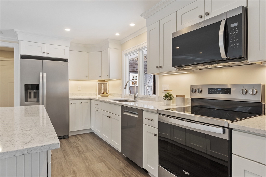 4 Richard Road Hudson, MA 01749 - Photo 5 of 40 a kitchen with a sink stove and refrigerator