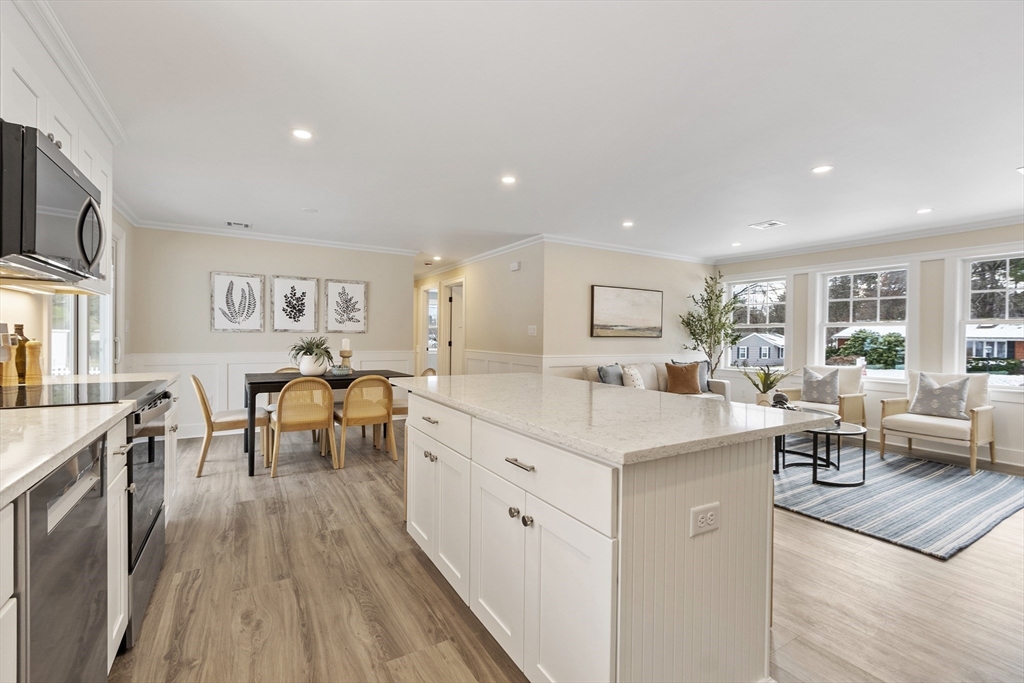 4 Richard Road Hudson, MA 01749 - Photo 7 of 40 a large white dining hall with stainless steel appliances granite countertop lots of counter top and couches