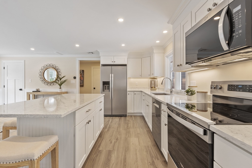 4 Richard Road Hudson, MA 01749 - Photo 9 of 40 a kitchen with stainless steel appliances granite countertop a sink stove and refrigerator