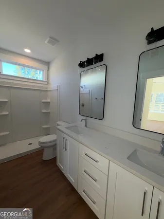 a bathroom with a toilet sink and mirror