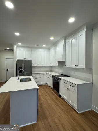 a kitchen with a sink stove and refrigerator