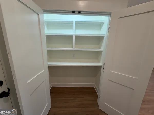 a view of walk in closet with empty racks