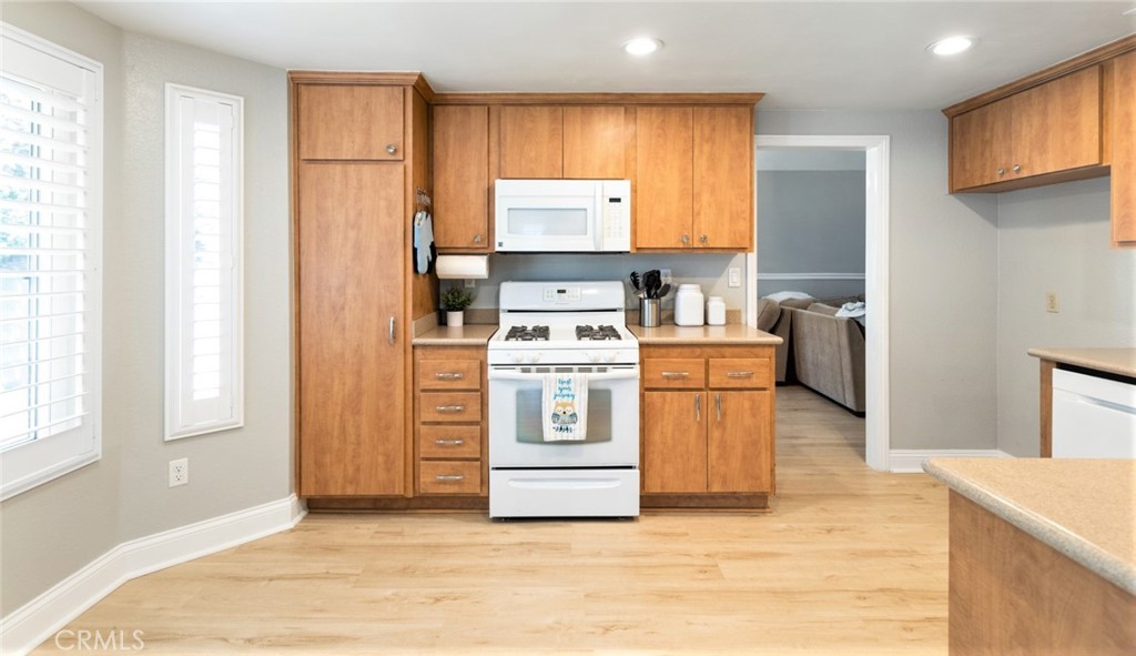 1942 Silverwood Circle Corona, CA 92881 - Photo 10 of 24 a kitchen with a stove top oven and cabinets