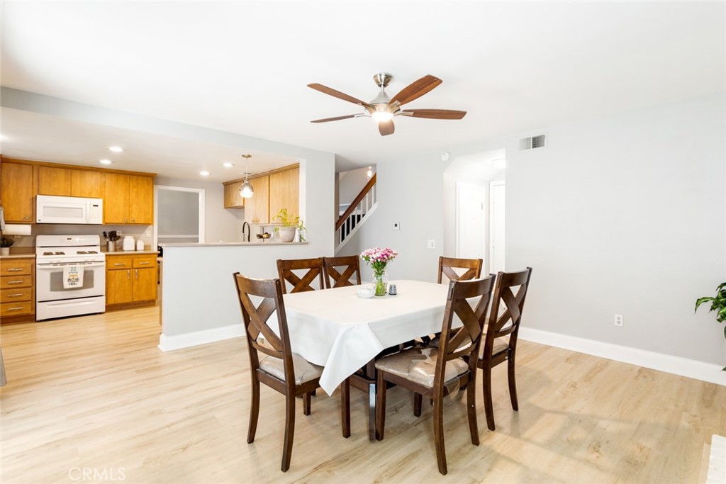 1942 Silverwood Circle Corona, CA 92881 - Photo 12 of 24 a view of a dining room with furniture and wooden floor