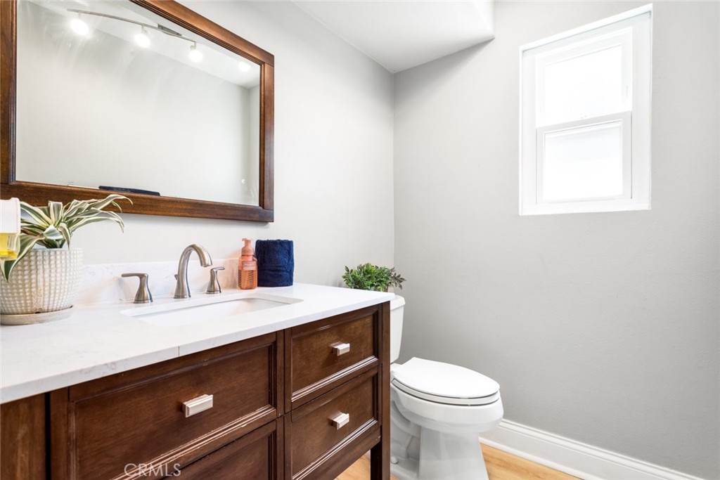 1942 Silverwood Circle Corona, CA 92881 - Photo 13 of 24 a bathroom with a sink a toilet and mirror