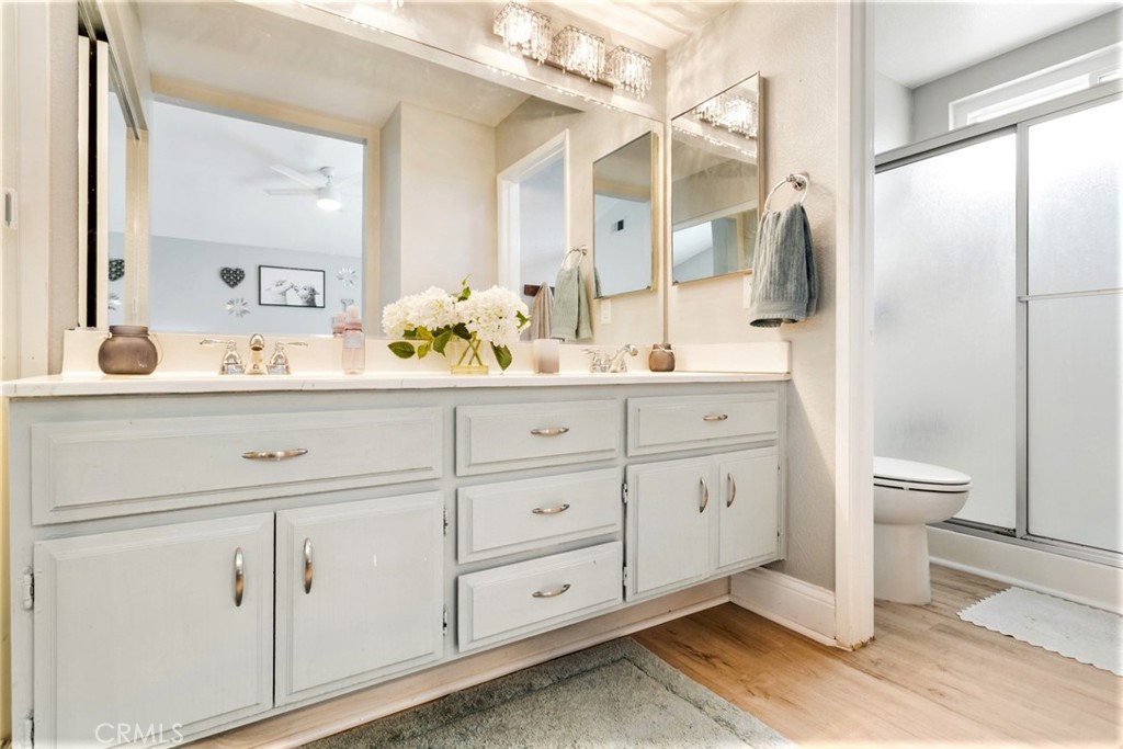 1942 Silverwood Circle Corona, CA 92881 - Photo 16 of 24 a bathroom with a double vanity sink and mirror