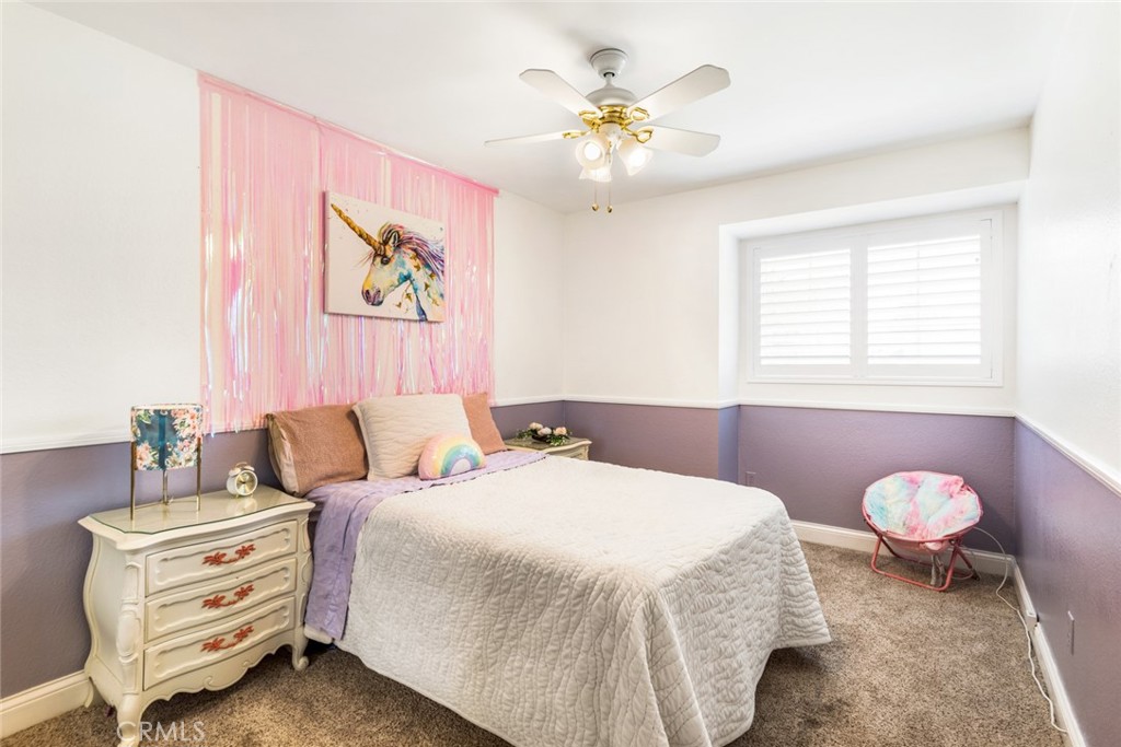 1942 Silverwood Circle Corona, CA 92881 - Photo 17 of 24 a bedroom with a bed and a chandelier