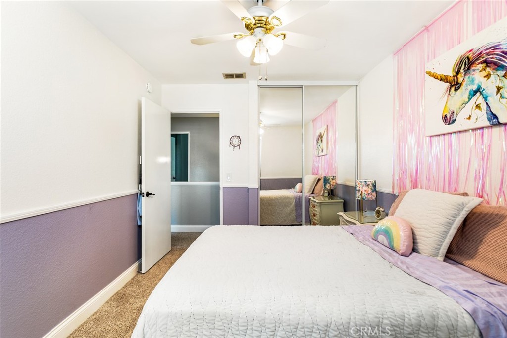 1942 Silverwood Circle Corona, CA 92881 - Photo 18 of 24 a bedroom with a bed and a chandelier