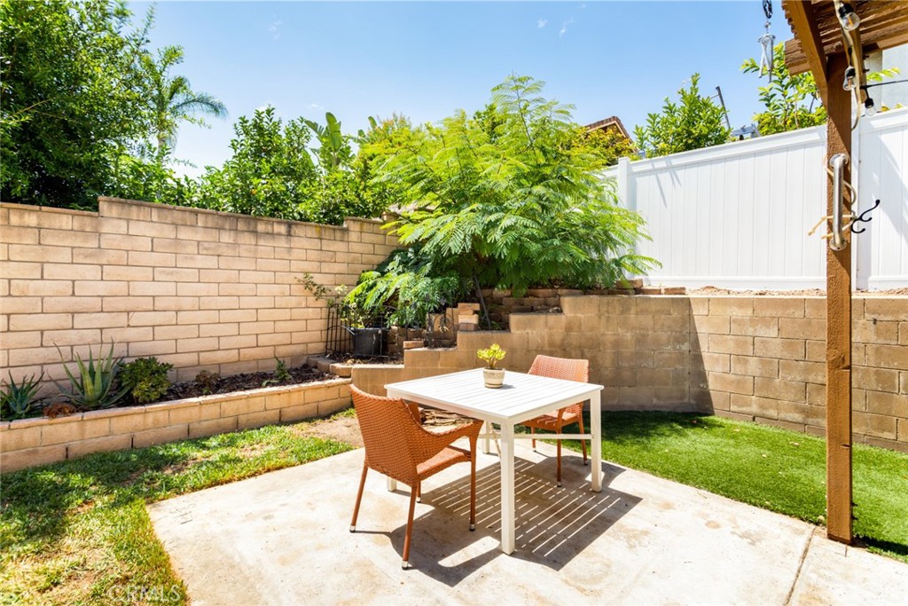 1942 Silverwood Circle Corona, CA 92881 - Photo 21 of 24 a view of a chairs and table in backyard of the house