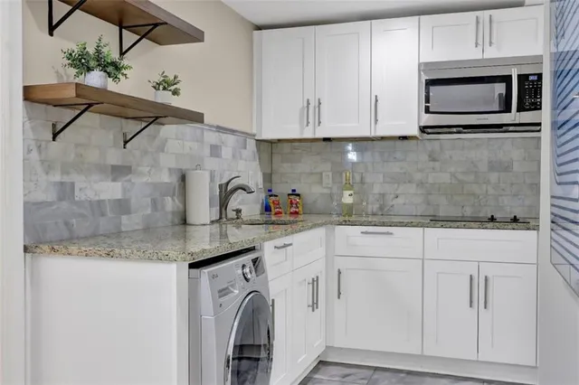 a kitchen with appliances cabinets and a counter top space