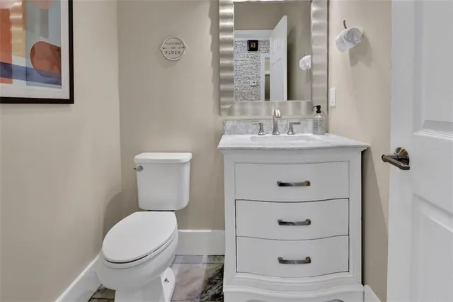 a bathroom with a sink a toilet and mirror