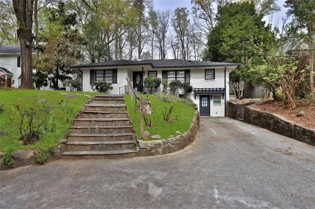 a bedroom with a bed and a television on the wall