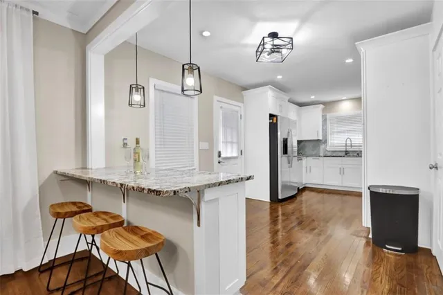 a kitchen with stainless steel appliances kitchen island a refrigerator and a stove top oven