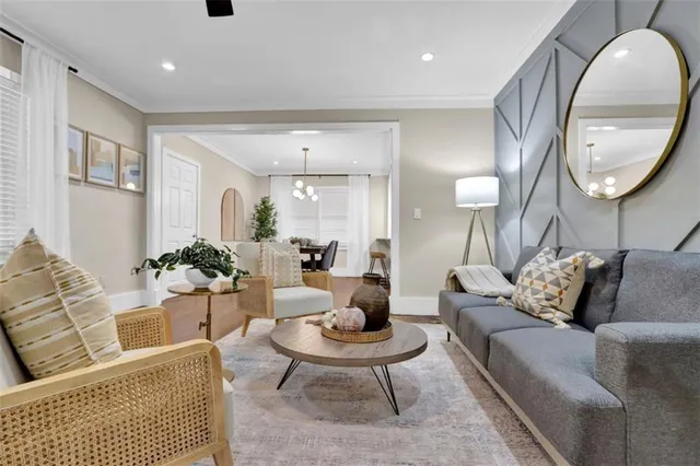 a living room with furniture a rug and a mirror