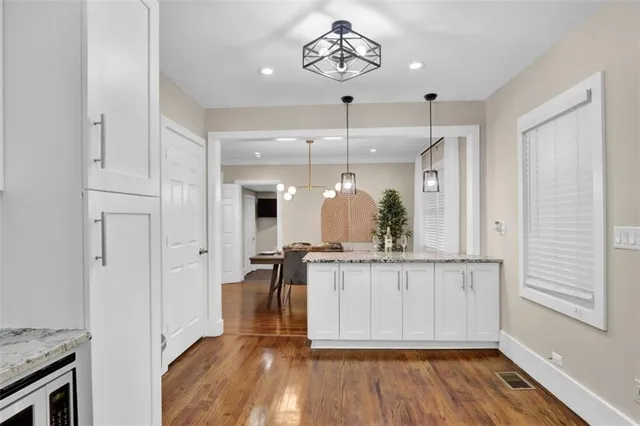 a view of a hallway with wooden floor and staircase