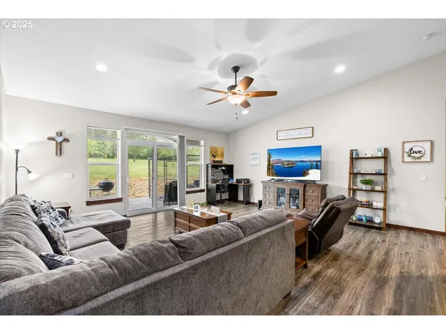 a living room with furniture fireplace and a large window